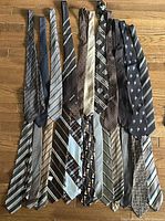 Photo showing 23 men's brown ties arranged horizontally with various stripe, polka dot and geometric patterns.