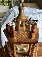 Wooden 3-tiered Christmas windmill showing angels playing instruments on top and fence details