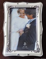 Silver 4x6 picture frame with decorative silver rose corners showing front side with wedding couple image