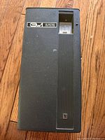 Top view of the 3 in 1 AC-battery cassette radio phono device showing textured black surface, cassette slot left side.