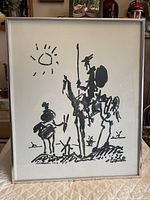 Full view of framed black ink print lithograph of Don Quixote and Sancho Panza, signed Picasso.