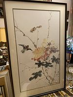 Full view of framed watercolor painting showing birds and flowers against light background.