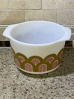 Side view of the vintage Pyrex Fish Scale mixing bowl showing exterior pattern and shape with handles.