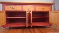 Front view of the wooden sideboard opened showing interior shelves and drawers