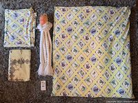 Lot content overview showing three items: two Winnie the Pooh themed blankets with diamond seasonal patterns and a white yarn baby decor item with a doll head.