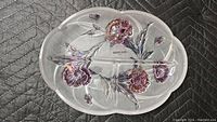 Top view of oval divided serving dish with floral decoration