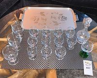 Full set of signed glassware including 16 goblets, decanter with stopper, and rectangular serving tray with floral design.