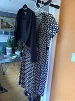 Evan Piccone geometric faux wrap dress with black and white pattern alongside black Frank Lyman bolero.