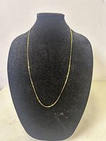 Chain displayed on black velvet bust