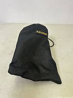 Black drawstring carrying pouch with Azuno brand tag on the front