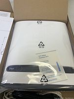 Front view of new GIGA HUB Bell Wi-Fi router inside plastic packaging and box. Wi-Fi settings sheet included.