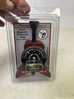 Photo showing the front view of the small magnetic centering head tool in its original packaging with visible dial, level, and branding