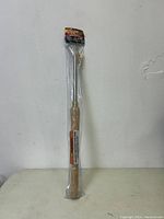 Full view of the Shop Fox bowl gouge lathe chisel sealed in plastic, showing the wooden handle and tool blade visible through packaging.