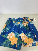 Front view of Speedo men's medium swim shorts with tropical floral print in Palace Blue color.