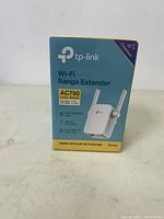 Front packaging of sealed TP-Link RE205 AC750 dual band Wi-Fi Range Extender. Shows product image, dual band support, AC750 speed specification, compatibility with Wi-Fi routers.