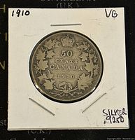 Front side of 1910 Canadian 50 cents silver coin showing denomination, maple leaf wreath, and crown.