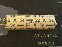 Full view of the wrapped coin roll showing denomination and value print.