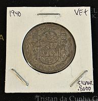 Reverse side of the 1940 Canadian silver 50 cents coin showing the Canadian coat of arms and denomination with the date 1940.
