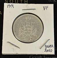 Obverse side showing crowned Canadian Coat of Arms and date 1959, marked 80% silver, VF condition noted.