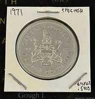 Reverse side of the 1971 Canadian silver dollar coin featuring the British Columbia coat of arms and commemorative inscriptions.