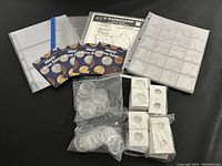 Photo showing weekly dime saver coin sets, clear plastic coin pages, white cardboard coin holders, and clear plastic banknote pages.