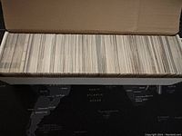 Long view of a box filled with hundreds of NHL collectible cards stacked upright.