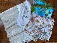 Four bedspreads folded together showing different fabrics and print patterns