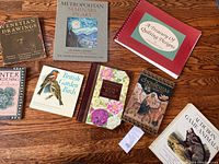 All eight vintage books arranged on wooden surface showing titles and covers