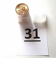 Front view of coin roll tube with top coin showing Sacagawea design, dated 2004 with 'P' mint mark, bright gold color.