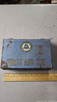 Top view photo of the vintage Bell Canada metal first aid kit box with visible rust and logo