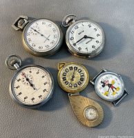 Top view of all 5 watches showing faces and dial details