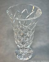 Close-up frontal view of vintage Waterford crystal vase showing intricate cut diamond pattern and flared rim.