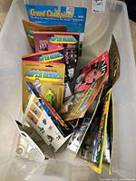 Overview of multiple carded action figures and model horse packaging in bin.