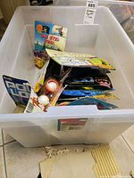 Plastic tub containing multiple sealed action figure blister packs viewed from above
