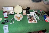Overhead shot of all jewelry pieces laid out on green cloth