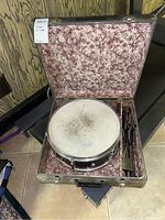 Leedy snare drum in padded case, case lid open showing marbled pink/white lining and drum in center compartment.