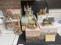 Photo showing all six David Winter cottages figurines with original boxes and certificate of authenticity included.