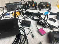 Photo showing Cipon controllers, Onewheel XR charger, controller cords, Linksys router, Wahoo USB device, and other cords
