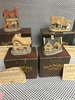 Front view of the four David Winter Cottages with original boxes and certificates
