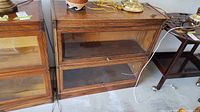 Front view of the oak barrister bookcase showing two stacked sections with glass drop-front doors