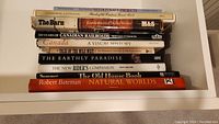 Stack of 11 nonfiction books showing titles on crafts, Canadian railroads, natural worlds, old houses, and history.