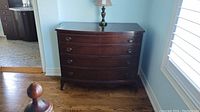 Full front view of the dresser with lamp on top