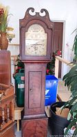 Full front view of entire grandfather clock case