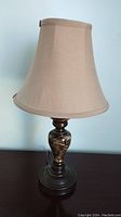 Full view of lamp showing metal base with decorative marbled pattern and fabric lampshade on top