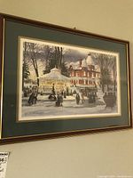Front view of a winter scene print signed by Walter Campbell, showing the framed artwork with snow-covered Victorian house and lit gazebo.