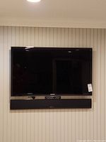 Front view of Samsung 46-inch TV and Definitive Technology XTR SSA-3 soundboard mounted on wall.