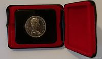 Canadian coin in a black and red velvet presentation case
