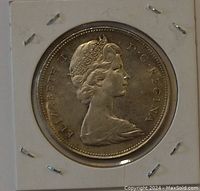 Obverse side of the 1966 Canadian silver dollar coin showing Queen Elizabeth II profile and inscriptions.