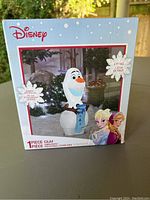 Photo of original Disney Frozen Olaf inflatable packaging box with product image and details