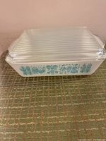 Full side view showing overall condition and size of Pyrex pan with lid.
